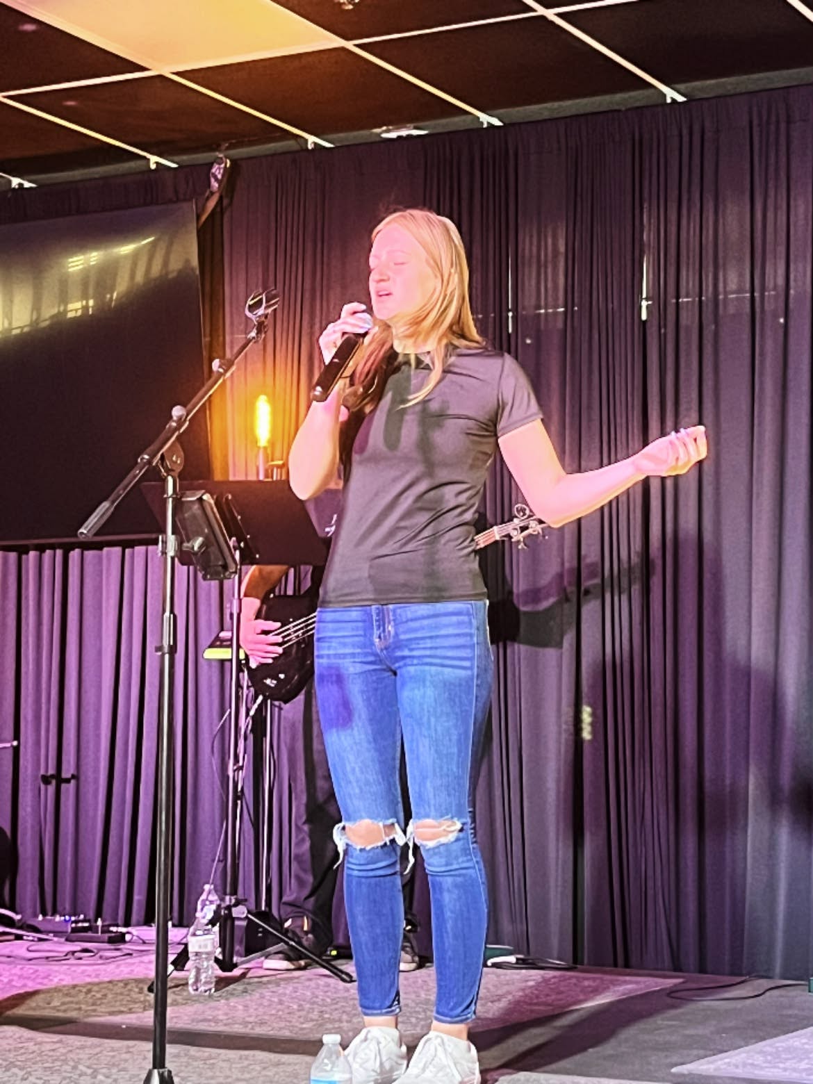 Worship leader singing during a Dunamis Church service